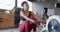 Focused african american woman training on rowing machine at gym, in slow motion