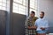 Focused African businessmen discussing paperwork together in an office