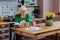 Focused aged white-haired female considering vedic book and making notes