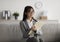 Focused arab female psychologist sitting on couch and writing in clipboard, offering professional counseling services