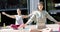 Focused asian female friends practicing yoga meditation on sunny terrace, slow motion