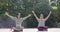 Focused asian female friends practicing yoga meditation on sunny terrace, slow motion