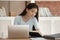 Focused Asian girl prepare for exam with book and laptop