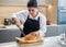 Focused Baker Cuts Crispy Warm Bread.