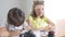 Focused beautiful girl studying online with boy. Portrait of concentrated Caucasian children looking at laptop and