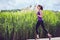 Focused beautiful woman running on sunny day on nautre background.