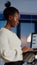 Focused black manager woman checking business report holding laptop