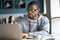 Focused black student studying online in coffeeshop