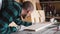 Focused bold carpenter with vintage moustache at work with wooden plank