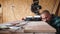 Focused bold carpenter with vintage moustache at work with wooden plank