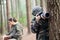 Focused boy with camera in forest