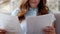 Focused business woman looking on financial diagrams at home office.