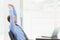 Focused businessman stretching at his desk