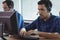 Focused businessman working on computer at call center