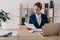 focused businesswoman in suit doing paperwork at workplace