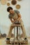 Focused busy man sitting on a wooden pottery wheel