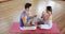 Focused caucasian couple practicing yoga in gym, slow motion