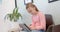 Focused caucasian girl patient using tablet sitting in hospital reception, copy space, slow motion