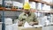 Focused Caucasian worker signing documents in warehouse.