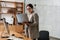 Focused charming woman in eyeglasses working with computer and laptop