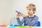 Focused child with 3d printing pen creating a plane