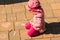 Focused child drawing on on stone tiles with chalk outdoors