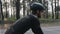 Focused confident cyclist riding bicycle in the park. Side follow shot. Cycling concept. Slow motion