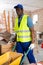 Focused construction worker pushing cart in building during renovation