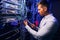 Focused data center employee checking cabling infrastructure