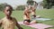 Focused diverse elementary school schoolgirls practicing yoga at stadium in slow motion