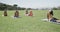 Focused diverse elementary school schoolgirls practicing yoga at stadium in slow motion