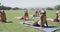 Focused diverse elementary school schoolgirls practicing yoga at stadium in slow motion