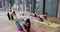 Focused diverse women in child pose together on mats in yoga class with female coach, slow motion