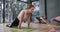 Focused diverse women in child pose together on mats in yoga class with female coach, slow motion