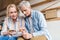 focused elderly couple counting money and taking notes in notebook during