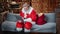 Focused elderly man in Santa Claus costume chatting use laptop. Wide shot on RED camera