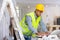 Focused engineer checks the house repair plan on a laptop