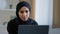 Focused ethnic female muslim arabian young woman girl islamic student businesswoman freelancer sits at home work on