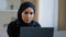 Focused ethnic female muslim arabian young woman girl islamic student businesswoman freelancer sits at home work on