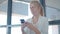 Focused female office worker texting message on cell