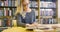 Focused female student with glasses working in the school library