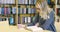 Focused female student reading books in school library