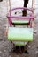 Focused frozen double pink and green swing for childrens in the winter