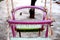 Focused frozen double pink and green swing for childrens in the winter