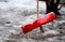 Focused frozen simple red swing for children in the winter