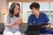 Focused general practitioner man pointing at laptop screen, sharing health tests laboratory results to senior female