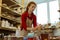 Focused ginger lady setting working place for painting