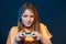 Focused girl playing video game with joystick