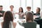 Focused group of young people sitting at a round table