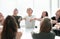 Focused group of young people sitting at a round table